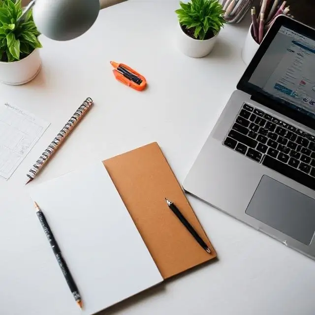 A creative workspace with a laptop and notebook.